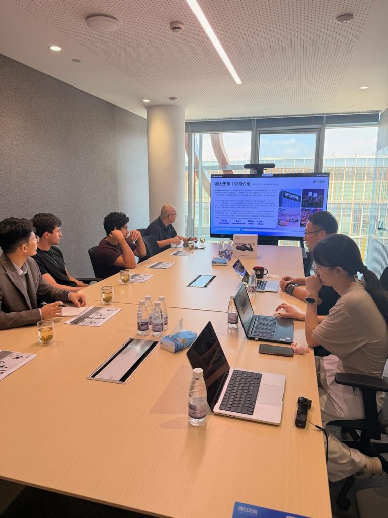 Delegation in a briefing at INFIFORCE, an embodied-AI robotics company, during a China investor tour